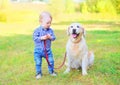 Little boy child with Golden Retriever dog on grass Royalty Free Stock Photo