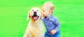 Little boy child and Golden Retriever dog together on the grass in the park Royalty Free Stock Photo