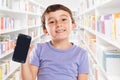 Little boy child holding smartphone smart cell phone library cellphone marketing ad advertising Royalty Free Stock Photo