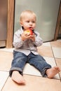 Little boy child kid eating apple fruit at home Royalty Free Stock Photo