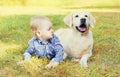 Little boy child lying with Golden Retriever dog on grass Royalty Free Stock Photo