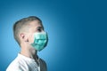 Little boy, a child in a medical mask on a bright background. The idea of an epidemic, influenza, protection from disease,