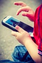 Little boy child playing games on mobile phone outdoor Royalty Free Stock Photo