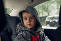 Little boy in a child safety seat sitting patiently in the back of a car Royalty Free Stock Photo