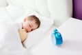 Little boy child sleeping in bed. Hugging his favourite teddy bear Royalty Free Stock Photo