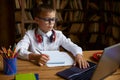 Little boy child studying at home table sitting front of computer laptop Royalty Free Stock Photo