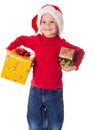 Little boy in christmas hat with gift boxes Royalty Free Stock Photo