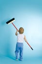 Little boy with cleaning swab over blue