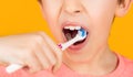 Little boy cleaning teeth with kids toothbrush. Dental hygiene. Little man brushing teeth. Happy child kid boy with Royalty Free Stock Photo