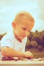 Little boy clever child playing checkers in park Royalty Free Stock Photo