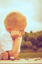 Little boy clever child playing checkers in park Royalty Free Stock Photo