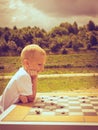 Little boy clever child playing checkers in park Royalty Free Stock Photo