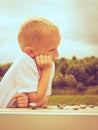 Little boy clever child playing checkers in park Royalty Free Stock Photo