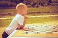 Little boy clever child playing checkers in park Royalty Free Stock Photo