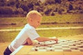 Little boy clever child playing checkers in park Royalty Free Stock Photo