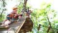 Little boy climbed to the top of the climbing wall, rearranging the carbines