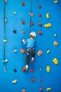 Little boy is climbing on blue wall Royalty Free Stock Photo