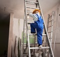 Little boy climbing ladder in apartment under renovation. Royalty Free Stock Photo