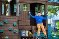 Little boy climbing ladder on slide at playground. Child is 5 7 Royalty Free Stock Photo