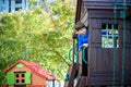 Little boy climbing ladder on slide at playground. Child is 5 7 year age. Caucasian, casual dressed in jeans and pullover. Royalty Free Stock Photo