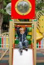 Little boy climbing on the playground. Kid play on kindergarten yard. Royalty Free Stock Photo