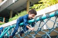 Little boy climbing on the rope at playground outdoor Royalty Free Stock Photo