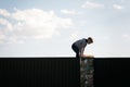 A little boy climbs over the fence Royalty Free Stock Photo