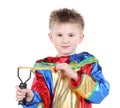 Little boy in clown costume holds slingshot and looks at camera