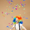 Little boy in clown wig jumping and having fun celebrating birth