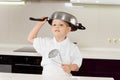 Little boy clowning around with kitchen utensils Royalty Free Stock Photo