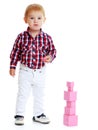 Little boy collects pink pyramid Royalty Free Stock Photo