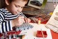 Little boy collects plastic model tank