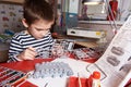 Little boy collects plastic model tank