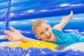 Little boy on colorful playground trampoline. Kids jump in inflatable bounce castle on kindergarten birthday party. Activity and p