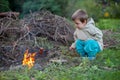 Little boy cooking sausages on a fire Royalty Free Stock Photo