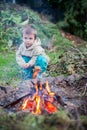 Little boy cooking sausages on a fire Royalty Free Stock Photo