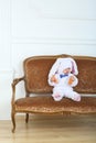 Little boy in costume bunny sitting on sofa with Royalty Free Stock Photo