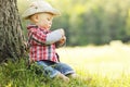 Little boy in a cowboy hat playing on nature Royalty Free Stock Photo