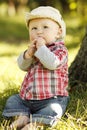 Little boy in a cowboy hat playing on nature Royalty Free Stock Photo