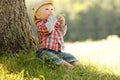 Little boy in a cowboy hat playing on nature Royalty Free Stock Photo