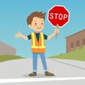 Little boy in crossing guard uniform in the street Royalty Free Stock Photo