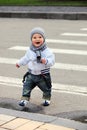 Little boy crossing a street