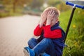 Little boy crying, fell from the scooter in open air