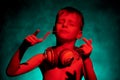 A little boy dances to the music with a spikelet and headphones. Royalty Free Stock Photo
