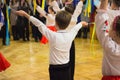 A little boy dancing in a white shirt