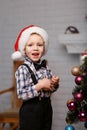 Little boy decorates a Christmas tree in the interior with Chris Royalty Free Stock Photo