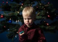 Little boy decorates the Christmas tree. Spruce with decorations. Kid and adornment Royalty Free Stock Photo