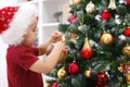 Little boy decorating Christmas tree Royalty Free Stock Photo
