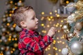 Little boy decorating Christmas tree with toy balls Royalty Free Stock Photo