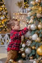 Little boy decorating Christmas tree with toy balls Royalty Free Stock Photo